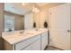Bathroom featuring a double sink vanity with quartz countertops and modern lighting at 4781 Rosette St, Castle Rock, CO 80104
