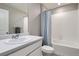 Bathroom featuring a single sink vanity, white subway tile and a shower and tub combo at 4781 Rosette St, Castle Rock, CO 80104