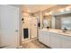 Bathroom featuring a walk-in shower with a sliding glass door and a dual sink vanity at 4781 Rosette St, Castle Rock, CO 80104