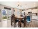 Dining area with an outdoor view, wood table with chairs and stainless appliances at 4781 Rosette St, Castle Rock, CO 80104