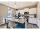 Kitchen with granite countertops, stainless appliances and island with barstool seating at 4781 Rosette St, Castle Rock, CO 80104
