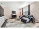 Cozy living room with a leather sofa, media cabinet, and a decorative rug at 4781 Rosette St, Castle Rock, CO 80104