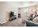 Inviting living room with cozy seating, plush carpet, and a modern entertainment center at 4781 Rosette St, Castle Rock, CO 80104