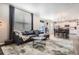 Comfortable living room with a leather sofa, rug, and large window with blinds at 4781 Rosette St, Castle Rock, CO 80104
