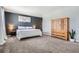 Spacious main bedroom featuring wall art, side tables, lamps and a large wardrobe at 4781 Rosette St, Castle Rock, CO 80104