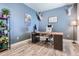 Office with wood laminate flooring, blue painted walls, and a mounted deer head at 4781 Rosette St, Castle Rock, CO 80104