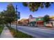 Street scene with colorful buildings, fashion banners, and a clear blue sky in a vibrant town at 4781 Rosette St, Castle Rock, CO 80104