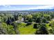 Stunning aerial view showcases mountain views with mature trees in the neighborhood at 1424 Cypress Cir, Lafayette, CO 80026
