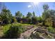 Large backyard featuring raised garden beds and a deck at 1424 Cypress Cir, Lafayette, CO 80026
