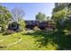 Charming backyard with mature trees, deck, and shed, perfect for outdoor living and entertaining at 1424 Cypress Cir, Lafayette, CO 80026
