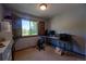 Office with a large window letting in natural light and neutral carpet and decor at 1424 Cypress Cir, Lafayette, CO 80026