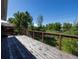 Expansive wooden deck with cable railing overlooking a lush green space at 1424 Cypress Cir, Lafayette, CO 80026