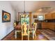 Charming dining area featuring hardwood floors, chandelier, and sliding glass doors to the backyard deck at 1424 Cypress Cir, Lafayette, CO 80026