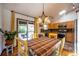 Dining area with hardwood floors, chandelier, and sliding glass doors to outdoor deck at 1424 Cypress Cir, Lafayette, CO 80026