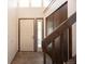 Bright foyer with tile flooring, a closet, and a stairway with wooden railing at 1424 Cypress Cir, Lafayette, CO 80026