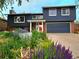 Stylish two-story home with brick accents, complemented by a colorful and well-maintained landscaped garden at 1424 Cypress Cir, Lafayette, CO 80026