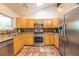 Bright kitchen featuring stainless steel appliances, granite countertops, tile floors, and skylight at 1424 Cypress Cir, Lafayette, CO 80026