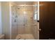 Modern shower with glass enclosure, tile surround, and updated fixtures at 1424 Cypress Cir, Lafayette, CO 80026