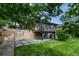 A serene backyard featuring a deck, patio, and lush lawn, perfect for outdoor living and entertaining at 2067 Depew St, Edgewater, CO 80214