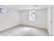 A bright basement room with neutral carpet, natural light, and white walls provides a calming atmosphere at 2067 Depew St, Edgewater, CO 80214