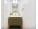 Stylish bathroom featuring modern fixtures, a decorative mirror, and green cabinet at 2067 Depew St, Edgewater, CO 80214