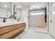 Modern bathroom with double vanity, marble floors, and a luxurious shower with rain head at 2067 Depew St, Edgewater, CO 80214