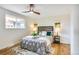 Comfortable bedroom with a ceiling fan, wooden floors, and bright, natural light at 2067 Depew St, Edgewater, CO 80214