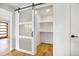 Pantry with sliding barn door and custom shelving, perfect for organization at 2067 Depew St, Edgewater, CO 80214
