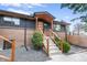 Inviting front entrance with modern wood accents and stylish stair railing at 2067 Depew St, Edgewater, CO 80214