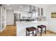 Bright kitchen with modern appliances, white cabinets, and an island with seating at 2067 Depew St, Edgewater, CO 80214