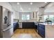 Contemporary kitchen featuring stainless steel appliances, an island, and hardwood flooring at 2067 Depew St, Edgewater, CO 80214