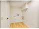 A functional laundry room with wood-look floors and white walls, ready for appliance hookups at 2067 Depew St, Edgewater, CO 80214