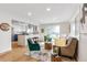 Open concept living room connected to a kitchen with an eat-in island and modern features at 2067 Depew St, Edgewater, CO 80214