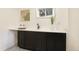 Convenient wet bar area with sink, dark cabinetry, and countertop seating at 2067 Depew St, Edgewater, CO 80214