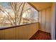 This outdoor balcony space features wood flooring and a view of surrounding neighborhood trees and buildings at 1827 Quail St # 8, Lakewood, CO 80215