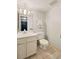 Cozy bathroom features a white vanity, toilet, and tiled floors, with a view into an adjacent room at 1827 Quail St # 8, Lakewood, CO 80215