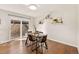 Dining area showcases a glass table with four chairs, complemented by floating shelves and a sliding glass door at 1827 Quail St # 8, Lakewood, CO 80215