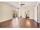 This main bedroom offers hardwood floors, a ceiling fan, a balcony, and an ensuite bathroom at 1827 Quail St # 8, Lakewood, CO 80215