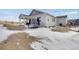 Backyard with trampoline and partial snow cover at 16805 Greenfield Dr, Monument, CO 80132