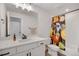 Bathroom featuring a white vanity, bright lighting, and a colorful shower curtain at 16805 Greenfield Dr, Monument, CO 80132