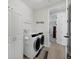 Well-organized laundry room with modern washer and dryer, storage cabinets, and stylish decor at 16805 Greenfield Dr, Monument, CO 80132