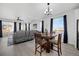 Open-concept living space with wood floors, a dining area, and lots of natural light at 16805 Greenfield Dr, Monument, CO 80132