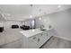 Basement wet bar features modern fixtures, white cabinets, and seating area at 16805 Greenfield Dr, Monument, CO 80132