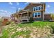 Landscaped backyard with a covered patio, grassy area, and tasteful plantings, providing a serene outdoor retreat at 13440 Monaco St, Thornton, CO 80602