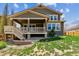 Exterior view of a two-story home featuring a backyard with green grass and a covered porch, blending indoor/outdoor living at 13440 Monaco St, Thornton, CO 80602