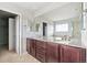 Bathroom featuring double sinks, granite counters, and dark wood cabinetry at 13440 Monaco St, Thornton, CO 80602