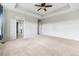 This bedroom features neutral carpet, ceiling fan, and access to an ensuite bathroom at 13440 Monaco St, Thornton, CO 80602