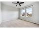 Comfortable bedroom featuring neutral carpet, ceiling fan, and large windows at 13440 Monaco St, Thornton, CO 80602
