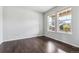 Bright bedroom featuring hardwood floors and large windows, creating an inviting living space at 13440 Monaco St, Thornton, CO 80602