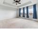 A bedroom featuring large windows, carpet, and a ceiling fan for comfortable living at 13440 Monaco St, Thornton, CO 80602